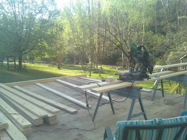 Miter saw and framing lumber on a deck under construction in Rathdrum